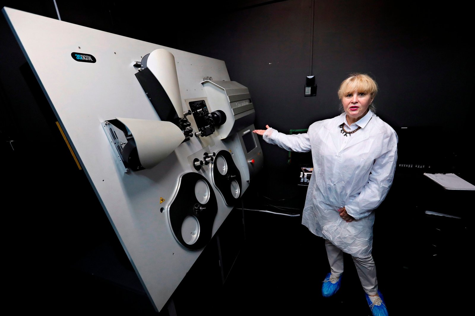 Bucharest (Romania), 25/06/2020.- Cornelia Popa, the general manager of Cinelabs Romania, poses next to the Cinevation 35 machine, a digital film recorder that can transfer a movie directly to positive print film ñ including both digital and analogue soundtracks, as EFE/EPA/ROBERT GHEMENT

